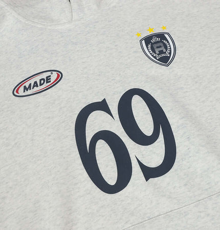 Close-up of an Oversized Hooded Sweatshirt – Loose Fit featuring number 69 and logo detail on a light gray fabric.