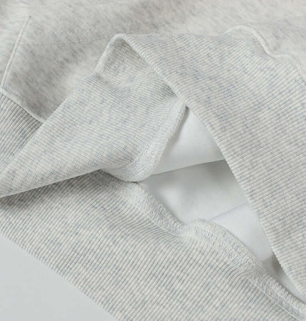 Close-up of the fabric details of an Oversized Hooded Sweatshirt – Loose Fit in light gray.
