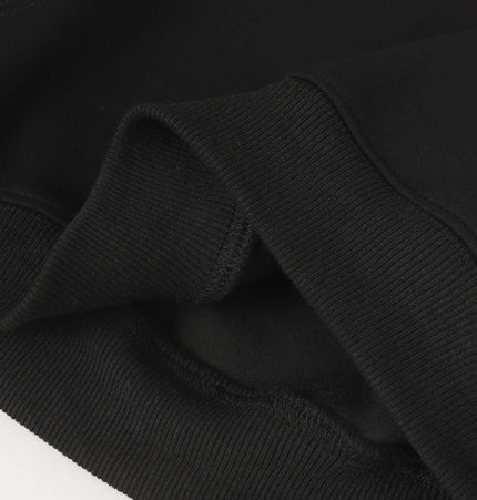 Close-up of the fabric and cuff detail of the Patchwork Embroidered Hoodie – Loose Fit, showcasing quality and comfort.