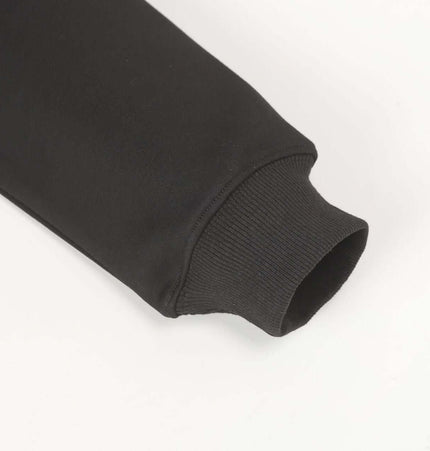 Patchwork Embroidered Hoodie – Loose Fit showing the cuff detail of a black sweatshirt.