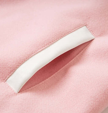 Close-up of the pocket detail on the Letter Embroidery Colorblock Jacket in soft pink fabric.
