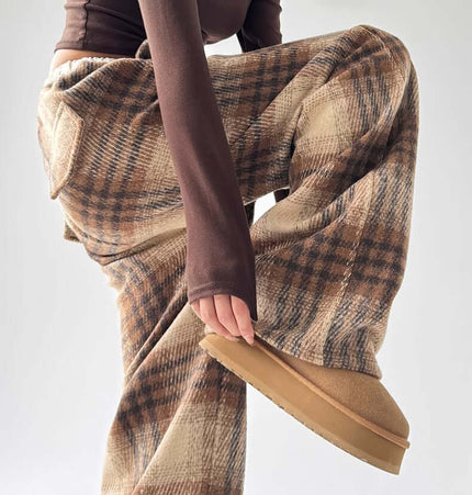 Model showcasing stylish Plaid Flannel Fleece Lined Winter Pants in a trendy outfit.