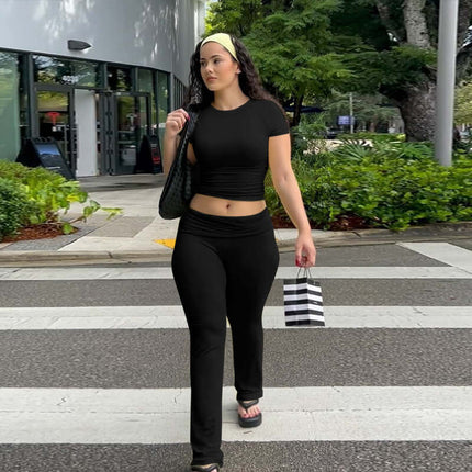 Pleated Short Sleeve Pants Set – Loose Fit worn by a woman in black on a city street with stylish accessories.