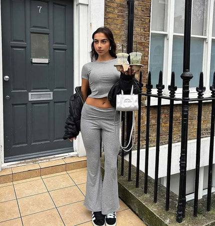 Stylish woman wearing Pleated Short Sleeve Pants Set – Loose Fit in gray, holding drinks on a city street.