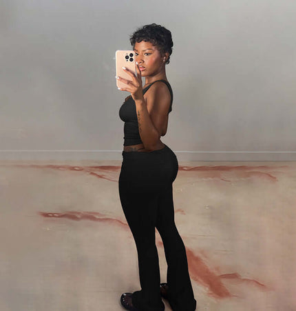 Model wearing Pleated Vest Two-Piece Set – Loose Fit, showcasing a sleek silhouette in casual black. Perfect for any occasion.