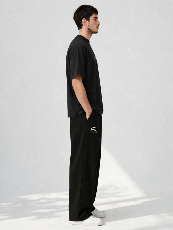 Side profile of the black 300 g/m² cotton stretch wide-leg pants