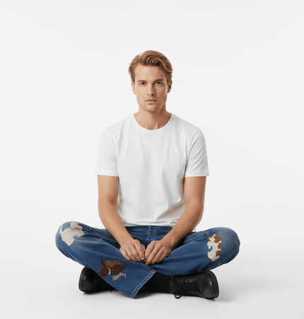 Puppy Embroidered Denim Jeans - Loose Fit model sitting cross-legged in a white t-shirt