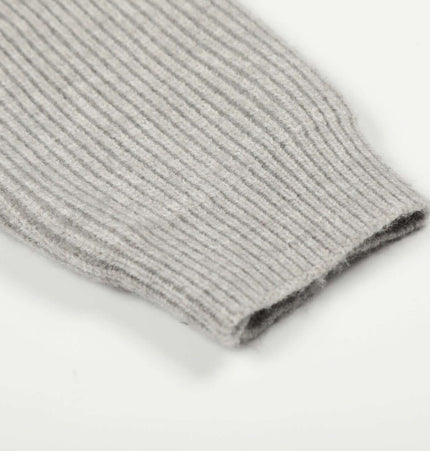 Close-up of the sleeve detail of a Retro Cardigan Sweater - Loose Fit in soft ribbed fabric.