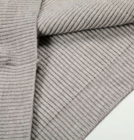 Close-up of the fabric texture of a Retro Cardigan Sweater - Loose Fit in soft gray knit.