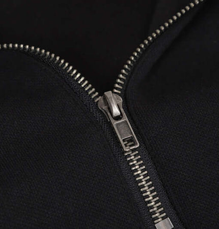 Close-up of the zipper on a Patchwork Half-Zip Hoodie, showcasing its high-quality metal detailing.