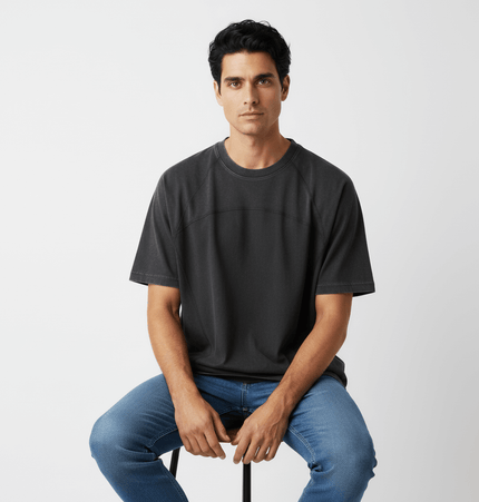 Retro Washed Letter Print TShirt – Loose Fit worn by a model sitting on a stool, styled with casual jeans.