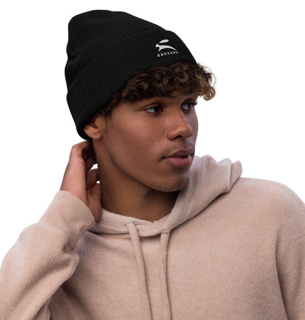 Stylish ribbed knit beanie worn by a young man, perfect for warmth and fashion.