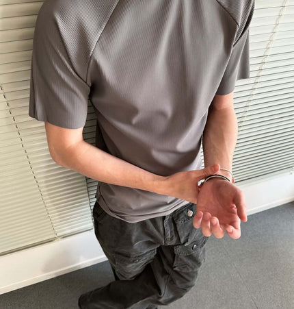 Seamless Jacquard TShirt – Loose Fit worn by a model showcasing a modern athletic style in a casual setting.