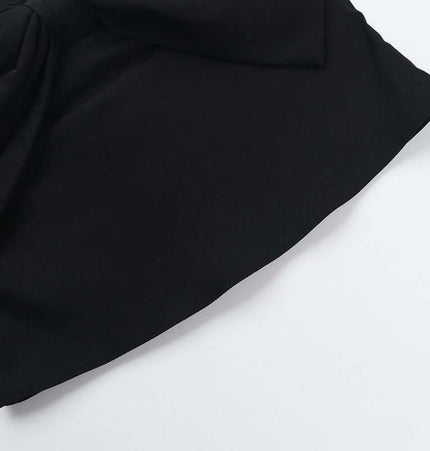 Close-up of the fabric and bow detail of the Slim Fit One-Shoulder Bow Top in black.