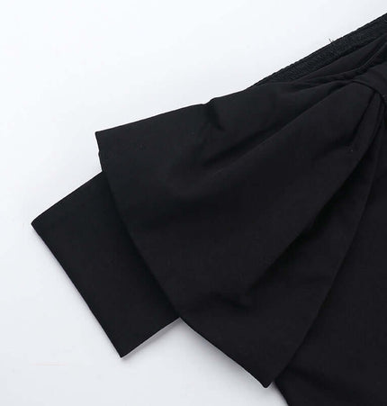 Close-up of the Slim Fit One-Shoulder Bow Top showing the bow detail and neckline design.