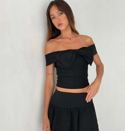 Slim Fit One-Shoulder Bow Top worn by model, featuring a bow accent and stylish one-shoulder design.
