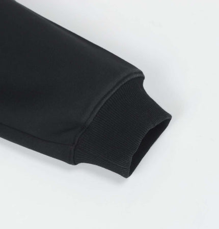 Close-up of the sleeve of the Splashing Ink Spliced Hooded Sweatshirt showcasing the ribbed cuff detail.