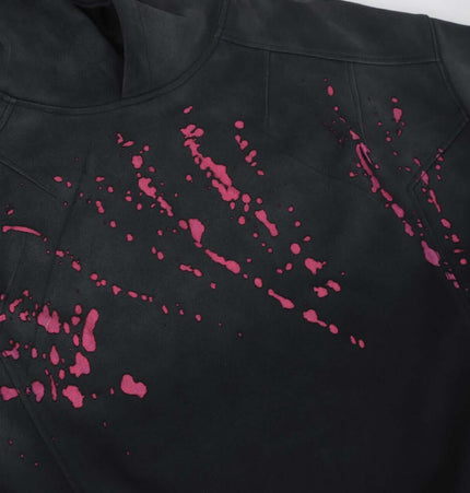 Splashing Ink Spliced Hooded Sweatshirt showing vibrant ink splash design on black fabric.