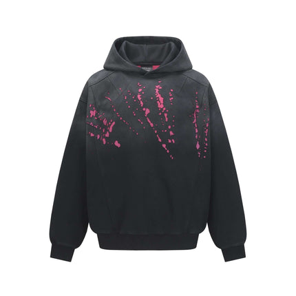 Splashing Ink Spliced Hooded Sweatshirt featuring a bold splattering ink design in pink on a black background.