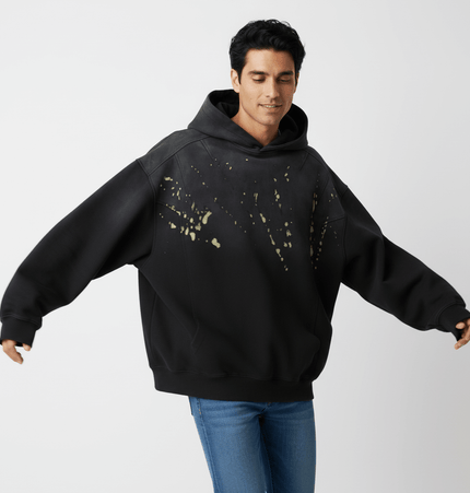 Splashing Ink Spliced Hooded Sweatshirt featuring a unique black and yellow splashing ink design, ideal for casual streetwear.