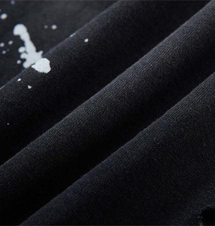 Close-up of the fabric texture of the Splatter Ink Tank Top – Loose Fit featuring paint splatter design.