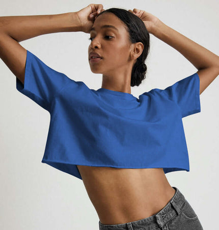 Sport Crop Cotton Top - Loose Fit displaying a model in a cropped blue top with short sleeves.