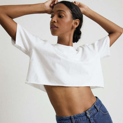 Sport Crop Cotton Top - Loose Fit modeled by a young woman showing a cropped silhouette in a stylish and casual manner.