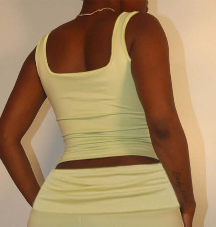 Back view of a woman wearing a Square Collar Pleated Two-Piece Set in soft green.