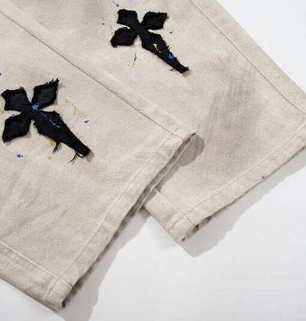 Straight Leg Patchwork Denim Jeans featuring cross patch embroidery and hand-painted color splatter detailing.