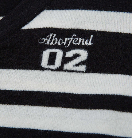 Close-up of the Aberfendl 02 striped fabric on a knit cardigan featuring a stylish design.