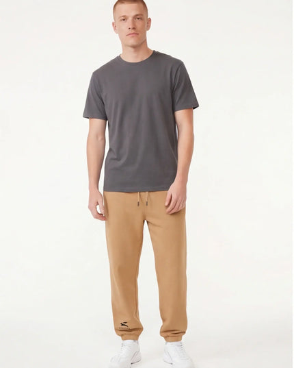 Detail shot of the Maison Grozavu Archival Umber Trousers in supreme — showing the effortless drape.
