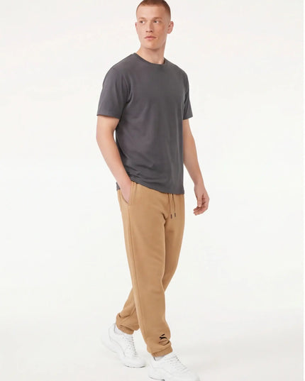 Detail shot of the Maison Grozavu Archival Umber Trousers in supreme — showing the sleek silhouette.