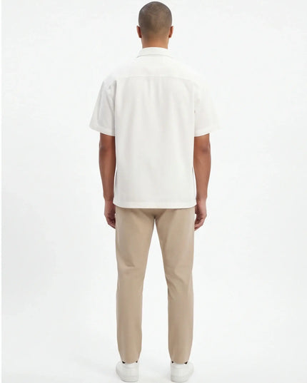 Rear view of the Maison Grozavu Earth Shirt Mark in style — showing the relaxed fit.
