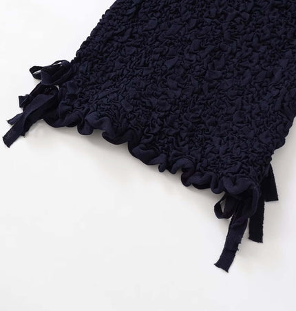 Close-up of the texture and bow detail on the hem of the Texture Knitted Bow Round Neck Top.