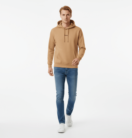 Urban Garment Dyed Hoodie – Loose Fit shown on a model walking, paired with jeans and sneakers.