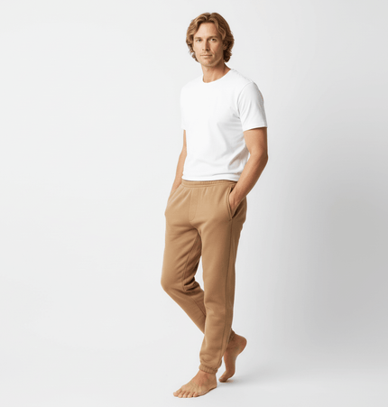 Man wearing Urban Heavyweight Fleece Sweatpants with a fitted white t-shirt, showcasing a casual style.