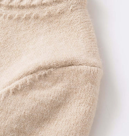 Close-up of the soft fabric texture of the Round Neck Casual Knit Sweater in ivory color.