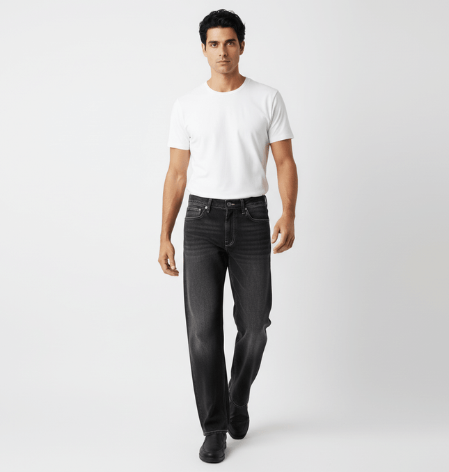 Man wearing Washed Straight Black Jeans – Loose Fit, paired with a white t-shirt, showcasing modern streetwear style.
