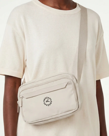 Onyx Crossbody Fit — three-quarter view showing the silhouette from the front-left angle in neutral