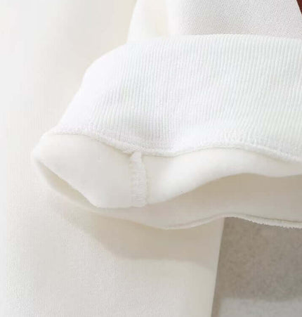 Detail of the sleeve cuff on the Grozavu Embroidered Pattern Hoodie – Loose Fit, showcasing soft fabric and design.