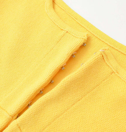Close-up of Slim Fit Knitted Short Tank Top with yellow knit fabric and round neckline design.